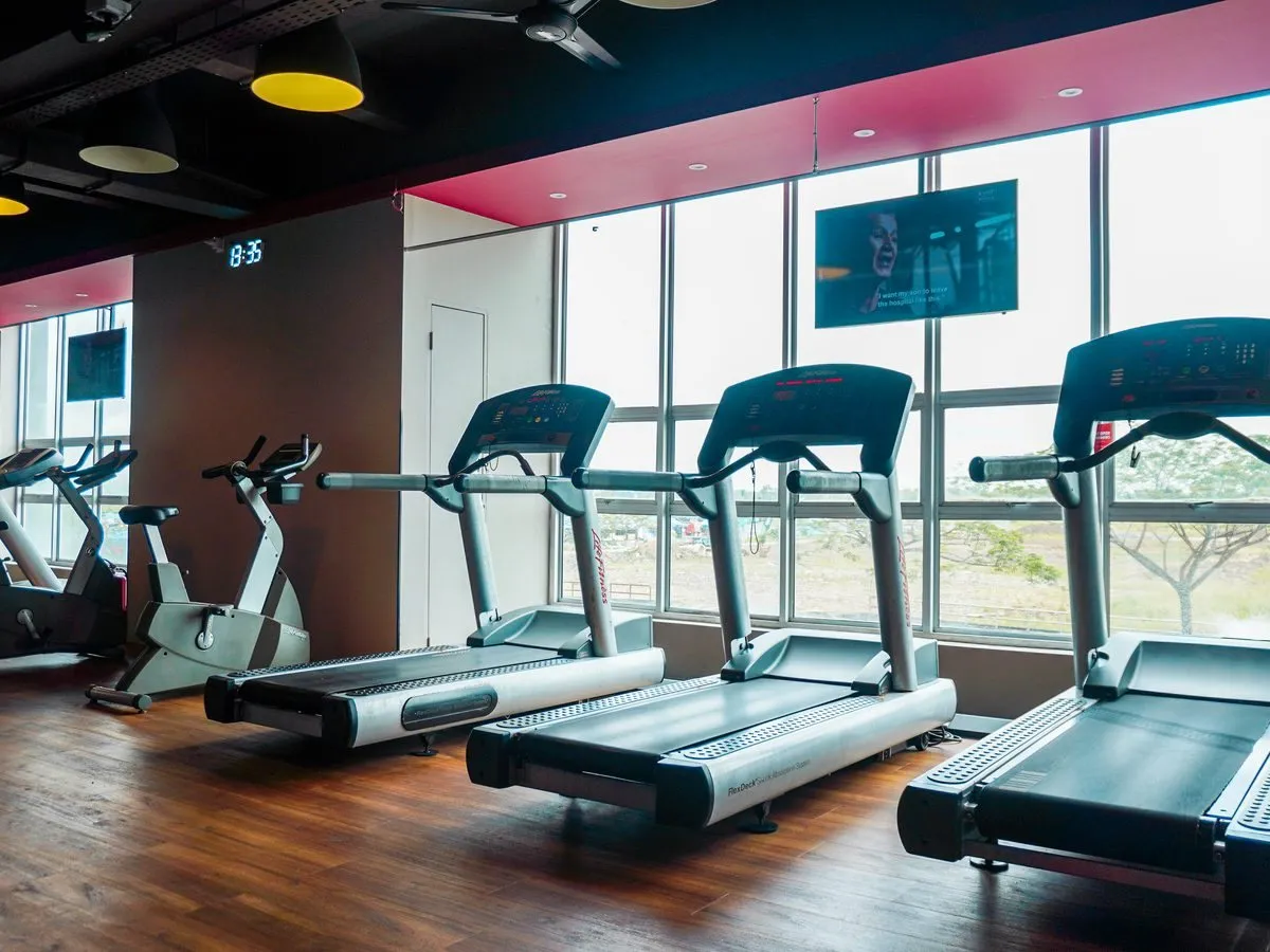 Treadmills by the window at Level Up Fitness Xpress Metrocity