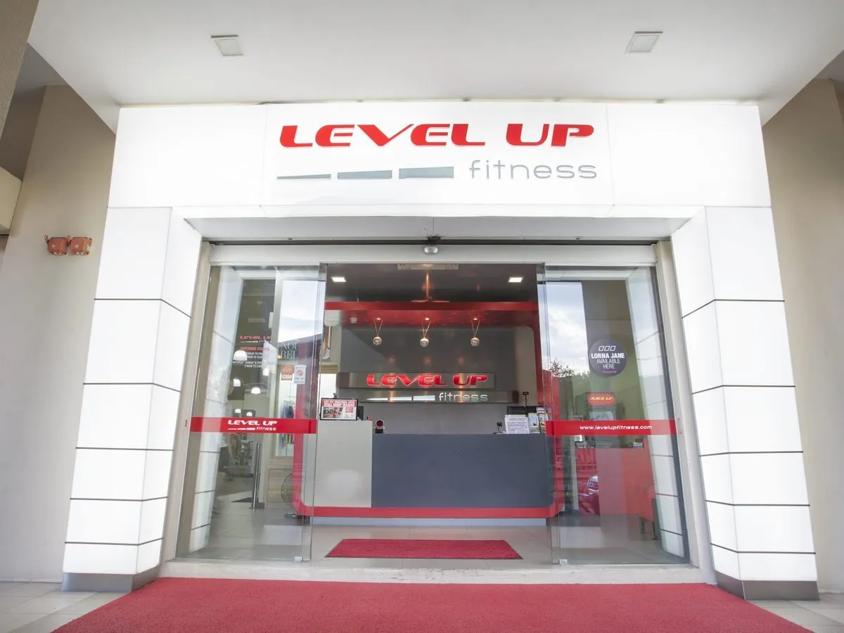 Glass entrance and front desk at Level Up Fitness Petanak, Kuching