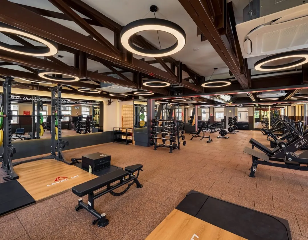 Free weights floor under timber roof trusses at Level Up Fitness Xpress Gaya Street, Kota Kinabalu